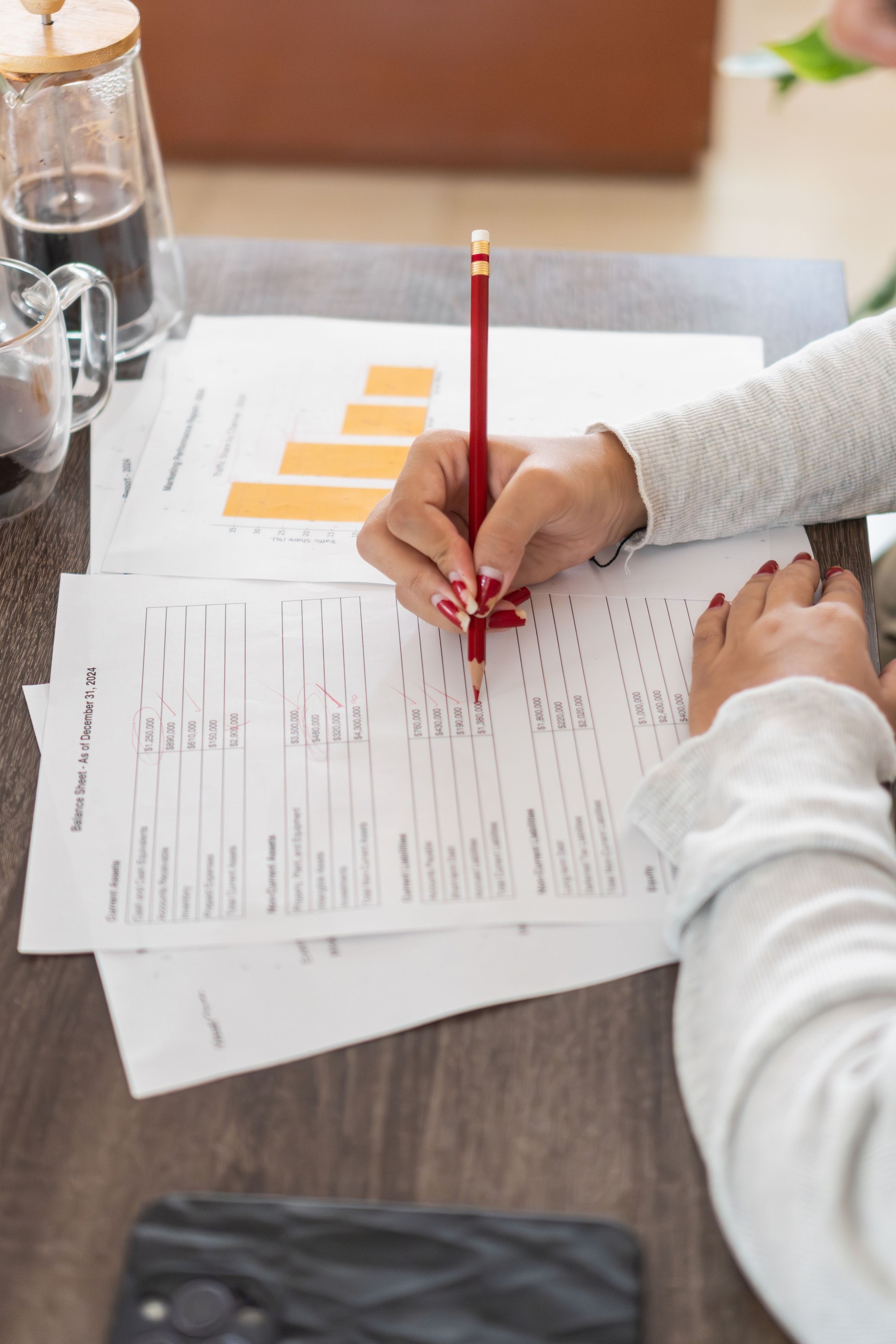 Businesswoman checking financial report and correcting mistakes at home office